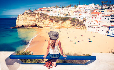 Woman tourist enjoying panoramic view of Portuguese village and holiday beach- Portugal, Algarve, Faro district