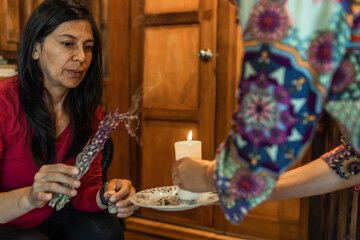 A mature woman burns cinnamon and lavender in a healing ceremony