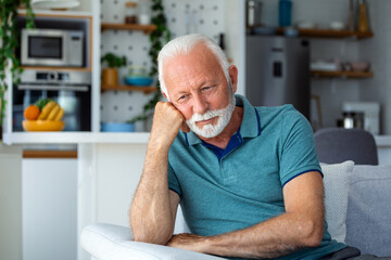 Fototapeta premium Bored tired sad mature man depressed lonely having no visitors of his children. Divorce , bachelor , health problems concept. Lockdown, unemployment, needless man on social distance