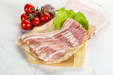 Sliced pork bacon oved board