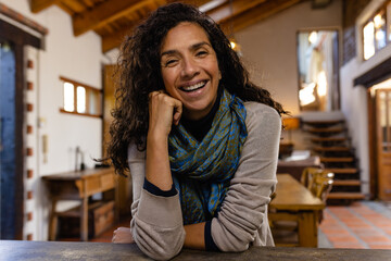 Happy biracial woman having video call in living room