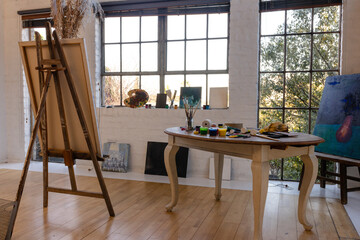 General view of home studio with easel and table with painting equipment