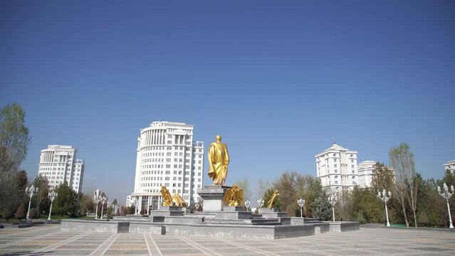 golden statue near the monument of neutrality