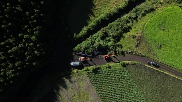 Machinery moving piping tubes in the mountains