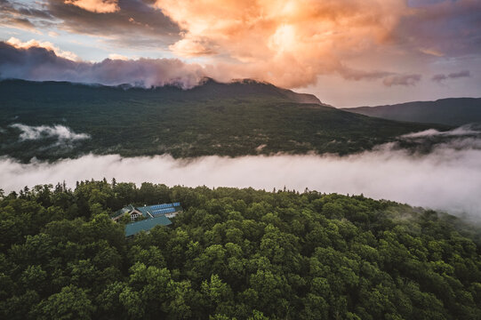 Aerial image thunderstorm clearing backcountry hut in Maine, sunset.