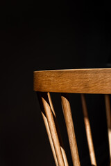 Curved wood dining room chair in moody lighting
