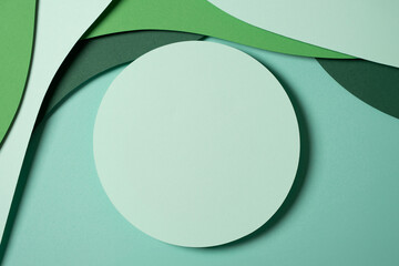 Blank light green round geometric shape podium platform on paper cut abstract geometric shape green background. Top view mock up for product display