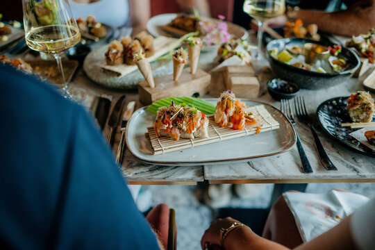 Table in restaurant filled with culinary food plates