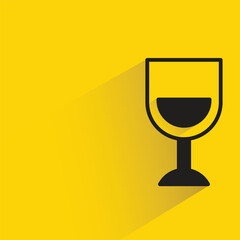 wine glass with shadow on yellow background