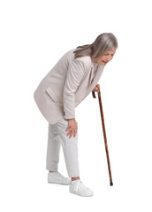 Senior woman with walking cane suffering from knee pain on white background