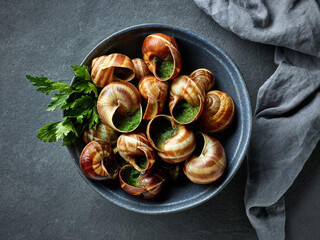 bowl of escargot snail filled with garlic and parsley butter - 622968387