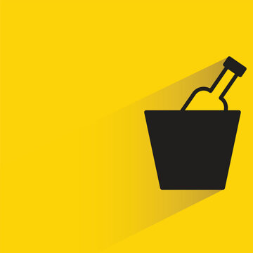 beer in bucket with shadow on yellow background