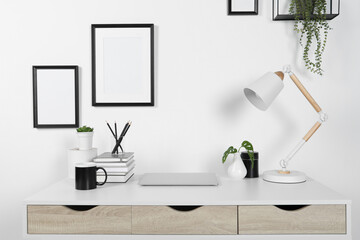 Naklejka na ściany i meble Home workplace. Laptop, lamp and stationery on white wooden desk