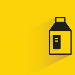 milk bottle with shadow on yellow background