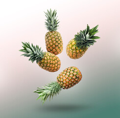 Fototapeta premium Many fresh pineapples falling on colorful background
