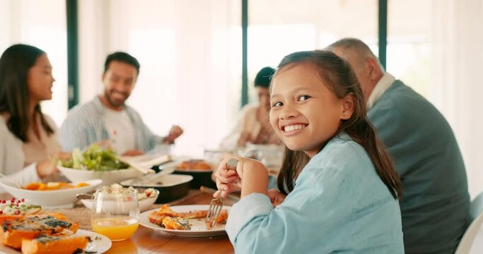 Thanksgiving, smile and a girl with her family eating food together while bonding in celebration. Love, lunch or brunch with the portrait of a female child and relatives at the dining room table