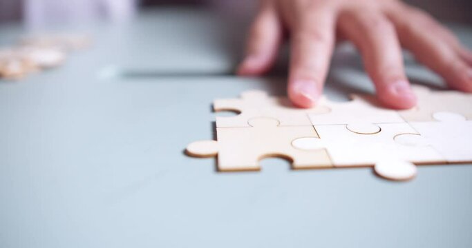Closeup hand of woman connecting jigsaw puzzle, Business solutions, success and strategy concept
