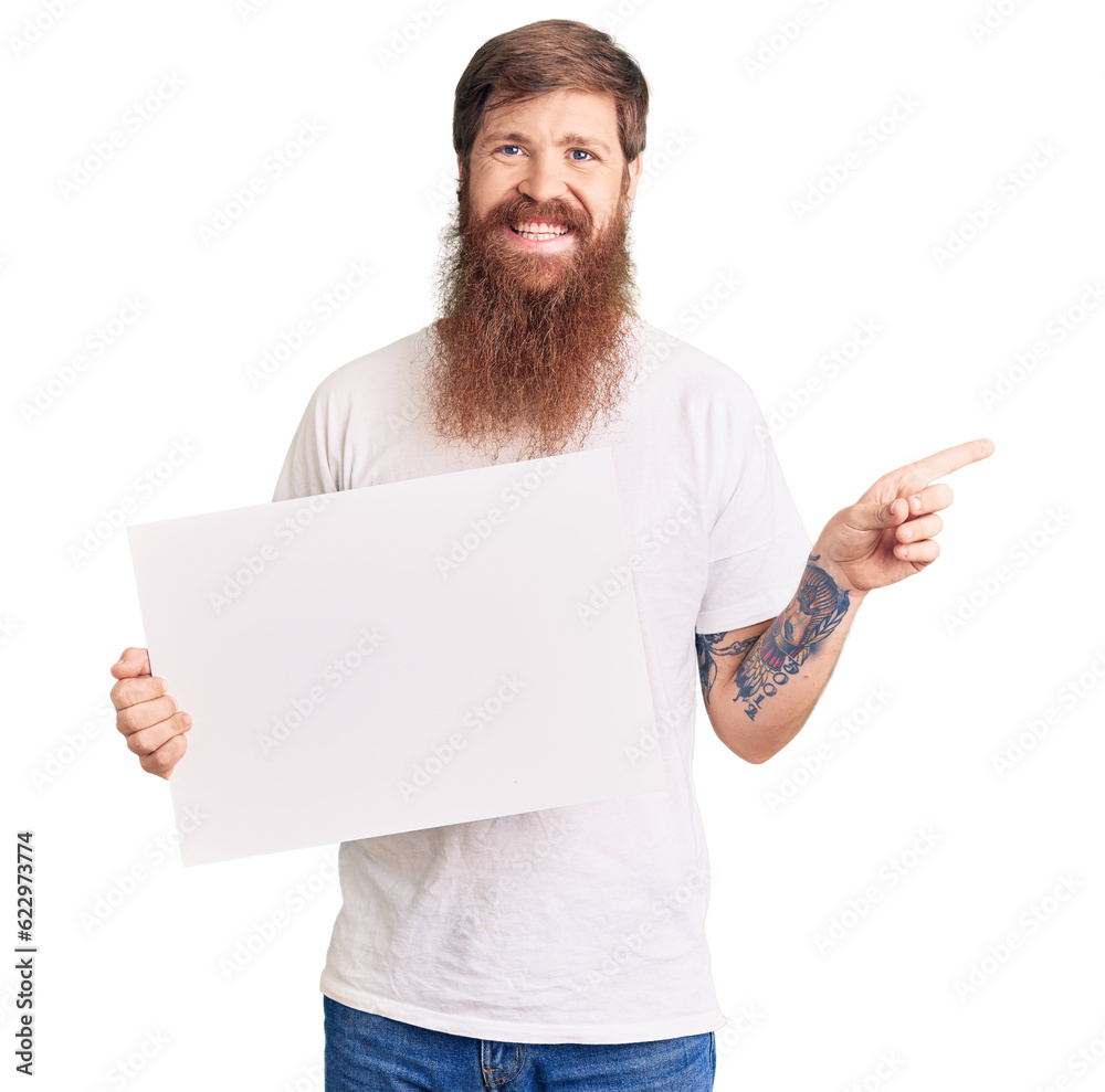 Canvas Prints Handsome young red head man with long beard holding blank empty banner smiling happy pointing with hand and finger to the side