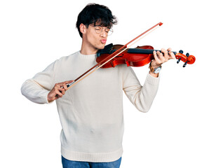 Handsome hipster young man playing violin looking at the camera blowing a kiss being lovely and sexy. love expression. © Krakenimages.com