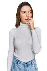 Young caucasian girl wearing casual clothes looking stressed and nervous with hands on mouth biting nails. anxiety problem.