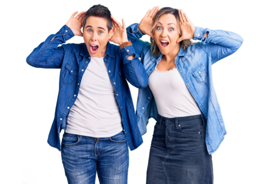 Couple of women wearing casual clothes smiling cheerful playing peek a boo with hands showing face. surprised and exited