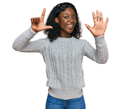 Beautiful african young woman wearing casual winter sweater showing and pointing up with fingers number seven while smiling confident and happy.