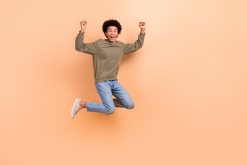 Full body size photo of young overjoyed guy celebrate victory competition fists up hooray wear...