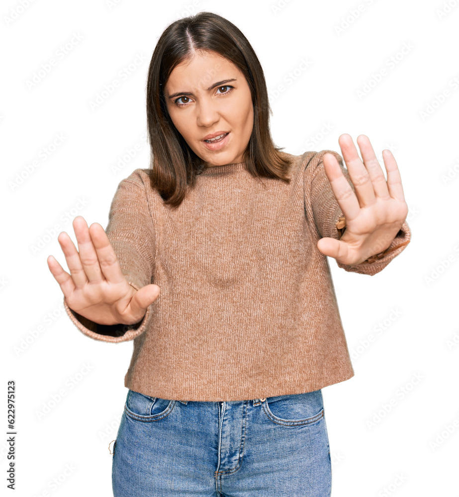 Sticker Young beautiful woman wearing casual clothes doing stop gesture with hands palms, angry and frustration expression