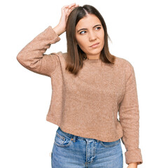 Young beautiful woman wearing casual clothes confuse and wondering about question. uncertain with...