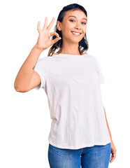 Young woman wearing casual clothes smiling positive doing ok sign with hand and fingers. successful expression.