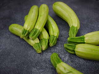 Fresh zucchini, green vegetables on local farmer market freshly harvested courgette, summer squash. raw in salads or cooked, extremely versatile, tender and easy to include in many light dishes
