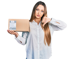 Beautiful caucasian woman holding delivery package with angry face, negative sign showing dislike...