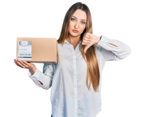 Beautiful caucasian woman holding delivery package with angry face, negative sign showing dislike with thumbs down, rejection concept