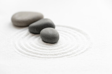 Fototapeta na wymiar Zen Garden with Grey Stone on White Sand Line Texture Background, Top View Black Rock Sea Stone on Sand Wave Parallel Lines Pattern in Japanese stye, Simplicity Day, Meditation,Zen like concept..