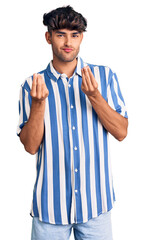 Young hispanic man wearing casual clothes doing money gesture with hands, asking for salary payment, millionaire business