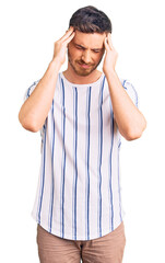 Handsome young man with bear wearing casual clothes suffering from headache desperate and stressed because pain and migraine. hands on head.