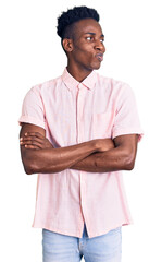 Young african american man wearing casual clothes smiling looking to the side and staring away thinking.