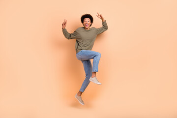 Fototapeta na wymiar Full body length photo picture advertisement date service stylish wearing denim jeans pullover guy v-sign jumping isolated on beige color background