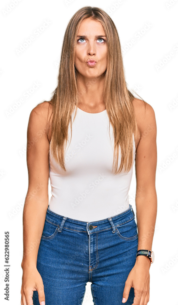 Canvas Prints Young blonde woman wearing casual style with sleeveless shirt making fish face with lips, crazy and comical gesture. funny expression.