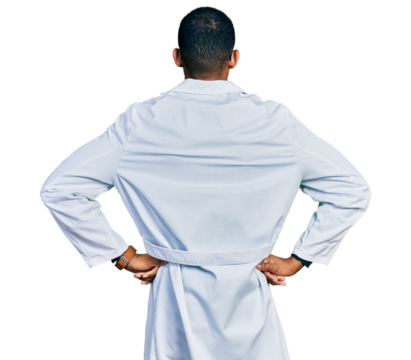 Young african american man wearing doctor uniform and stethoscope standing backwards looking away with arms on body