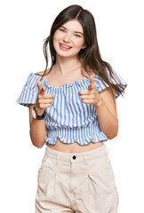 Young beautiful caucasian girl wearing casual clothes pointing fingers to camera with happy and funny face. good energy and vibes.
