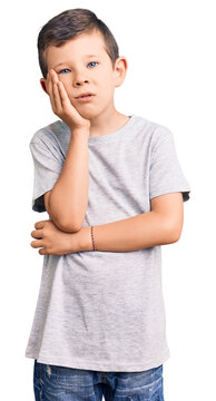 Cute blond kid wearing casual clothes thinking looking tired and bored with depression problems with crossed arms.