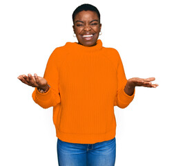 Young african american woman wearing casual clothes clueless and confused expression with arms and...