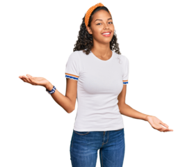 Young african american girl wearing casual clothes smiling cheerful with open arms as friendly welcome, positive and confident greetings