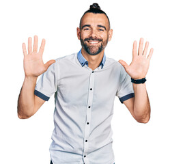 Hispanic man with ponytail wearing casual white shirt showing and pointing up with fingers number ten while smiling confident and happy.
