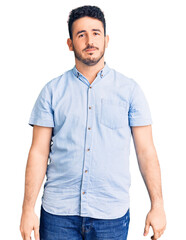 Fototapeta premium Young hispanic man wearing casual clothes with serious expression on face. simple and natural looking at the camera.