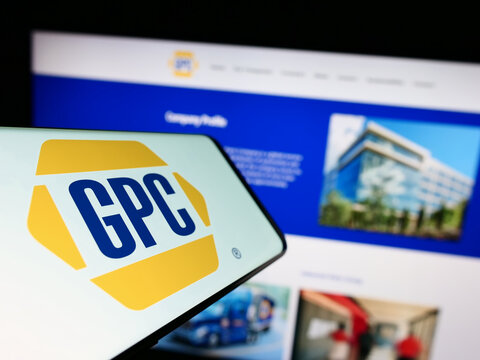 Stuttgart, Germany - 07-01-2023: Smartphone with logo of American business Genuine Parts Company (GPC) on screen in front of website. Focus on center-left of phone display.