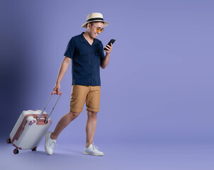 full body portrait image of traveling asian man using phone on purple background.