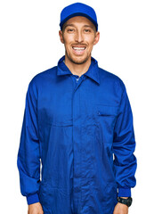 Bald man with beard wearing builder jumpsuit uniform with a happy and cool smile on face. lucky person.