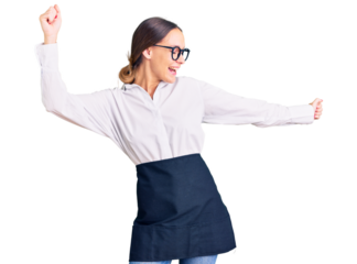 Beautiful brunette young woman wearing professional waitress apron dancing happy and cheerful, smiling moving casual and confident listening to music